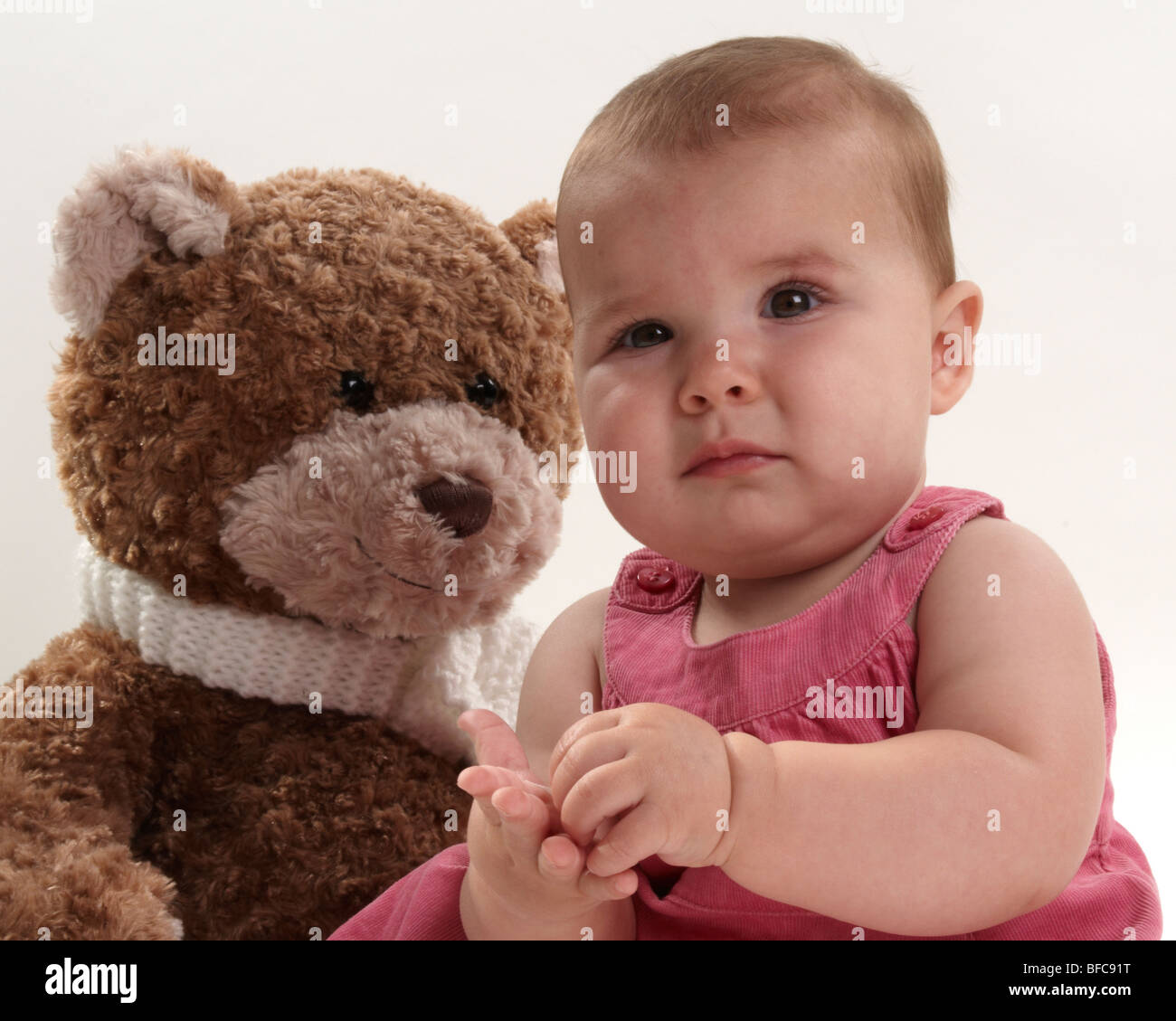 Baby Girl and her Big Brown Teddy Stock Photo