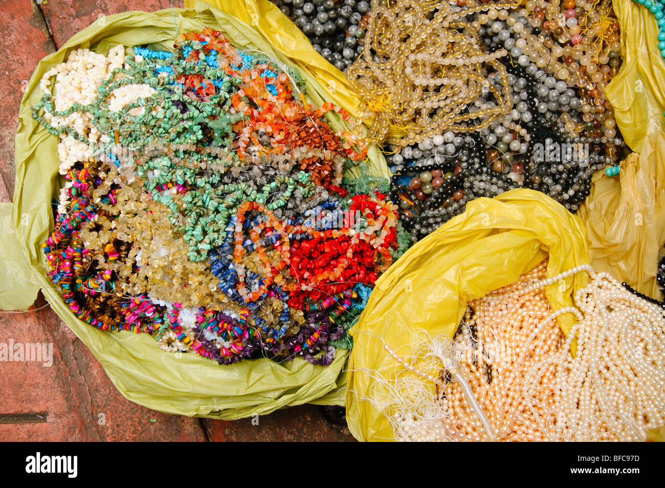 Beads, colored gems, pearls and stones for sale in Chinatown, Bangkok, Thailand Stock Photo