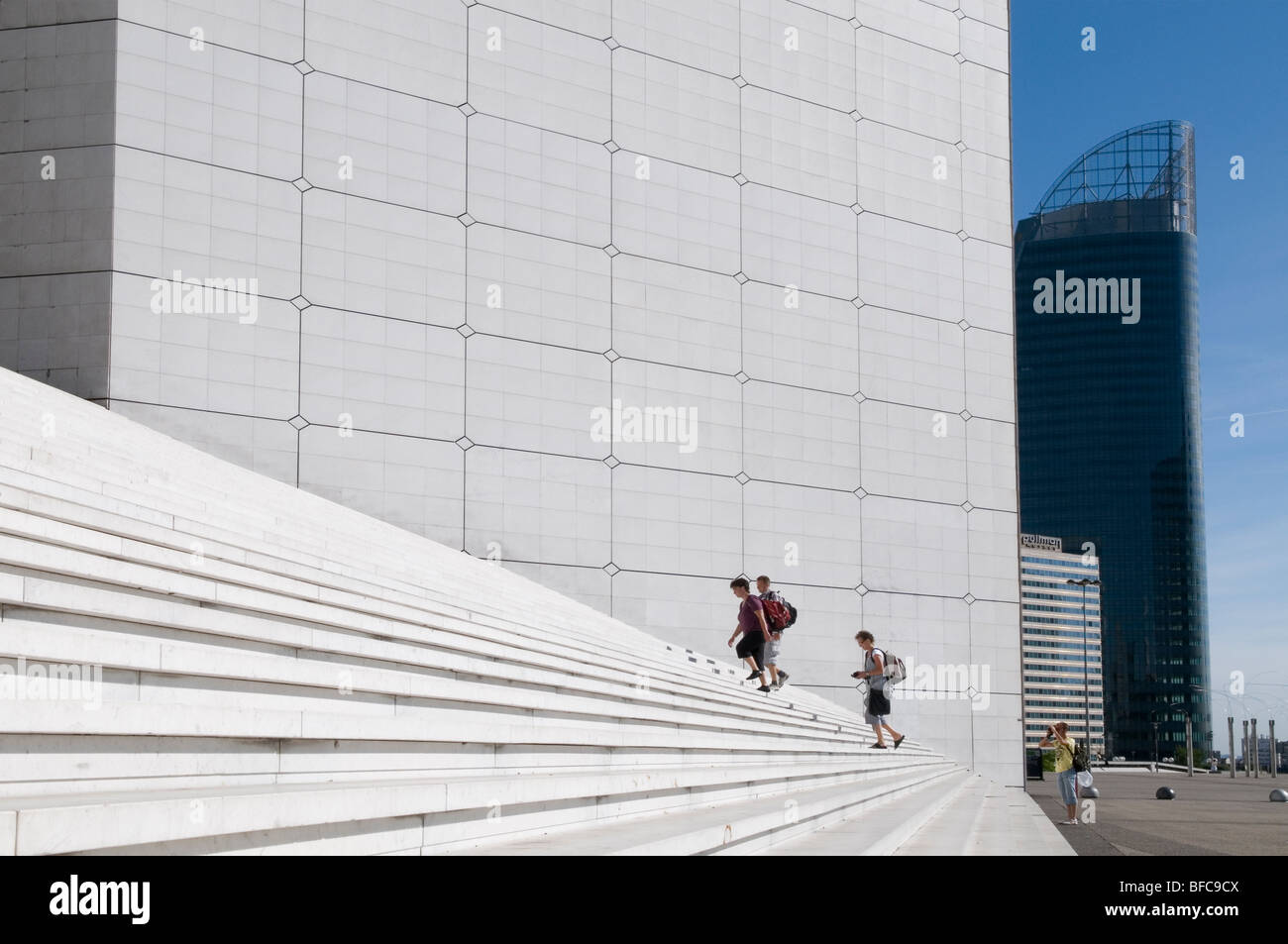 climbing the steps of the grande arche - la Defense - Paris - France Stock Photo