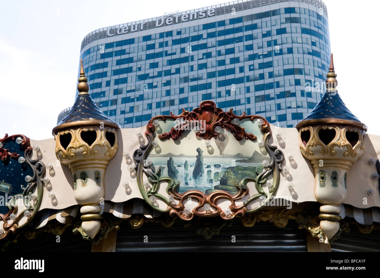 Top of a merry-go-round in front of a modern building - la Defense - Paris - France Stock Photo