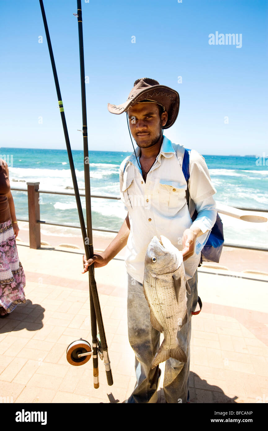 Fisherman on the Umhlanga Rocks sea wall. Near Durban, South Africa. Stock Photo