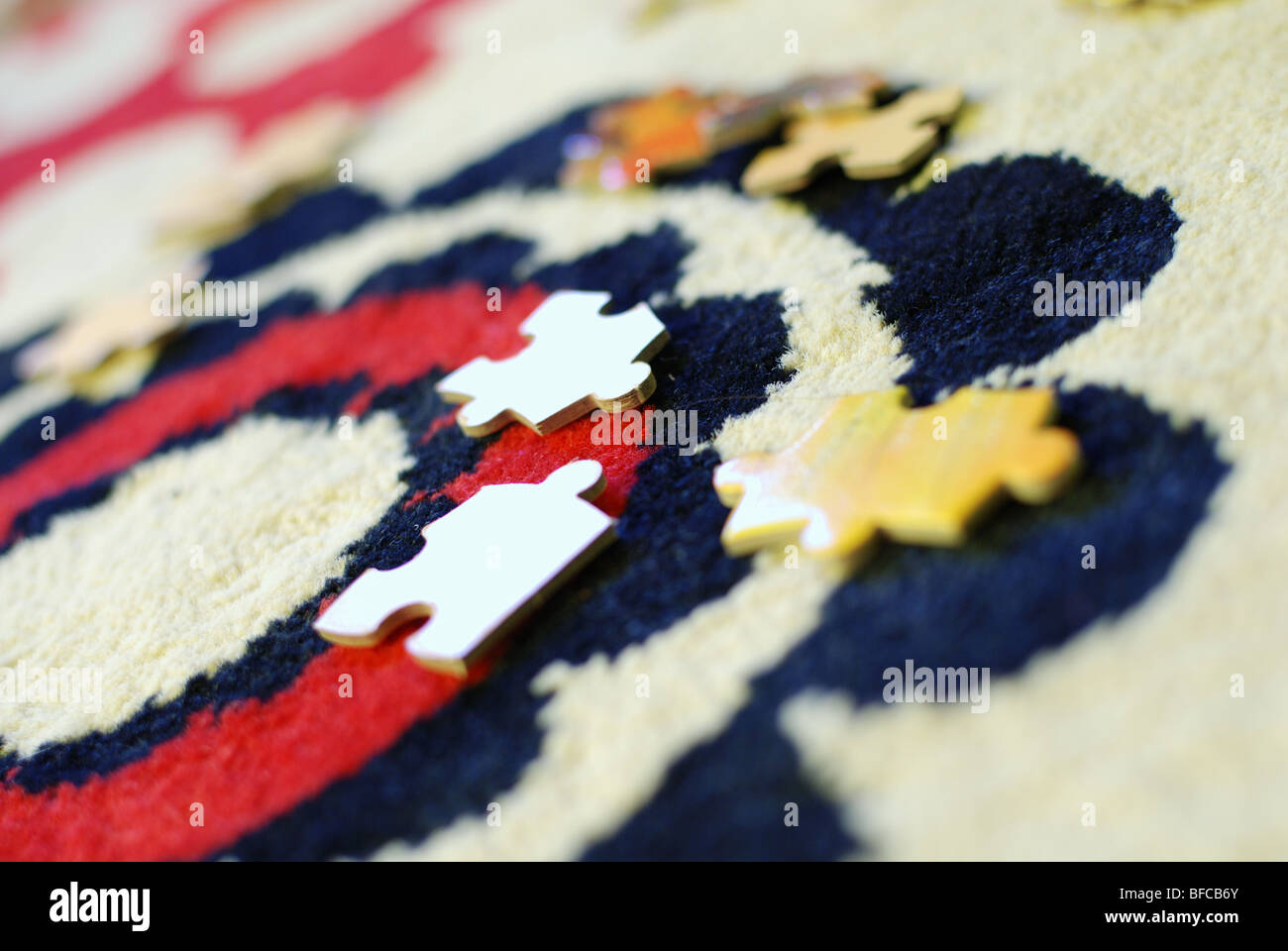 Puzzle pieces on a carpet Stock Photo Alamy