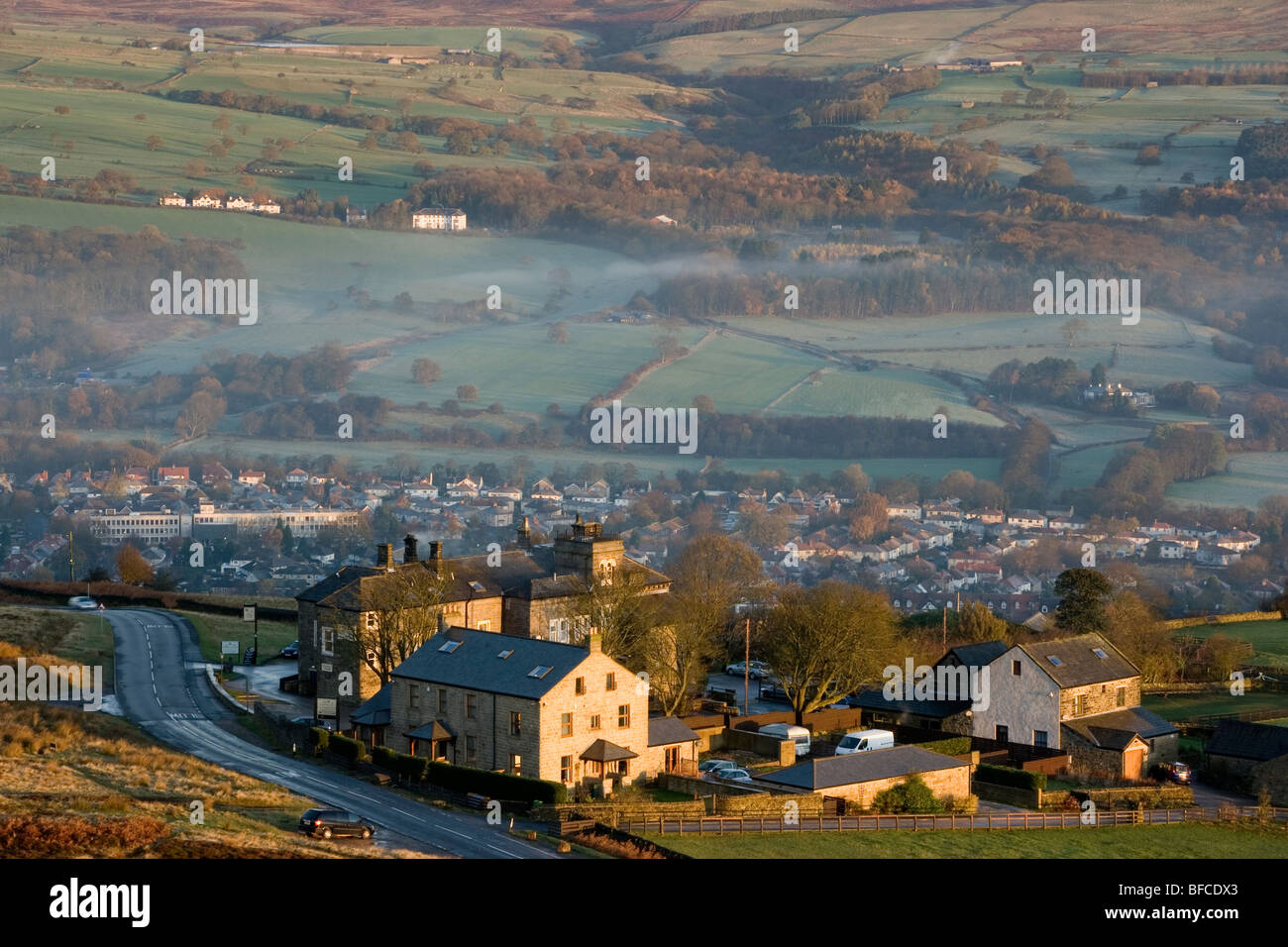 The Cow and Calf hotel on Ilkley Moor and the town of Ilkley are bathed in dawn light, Ilkley