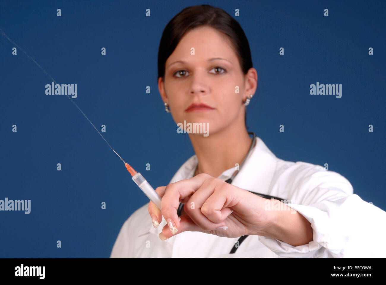 Young female doctor holding a syringe in her hand Stock Photo