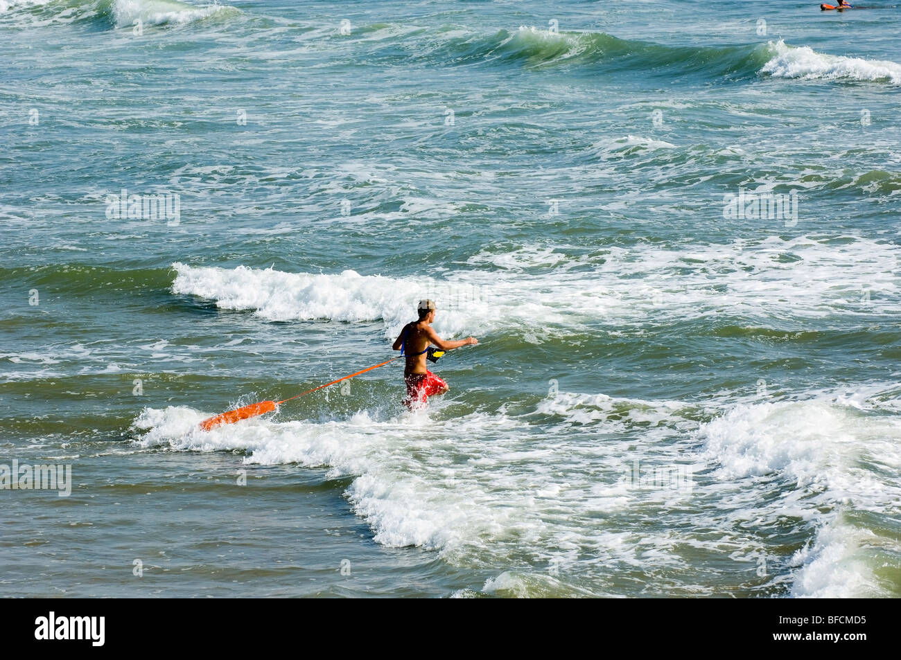 lifeguard running to rescue a drowning person Stock Photo Alamy