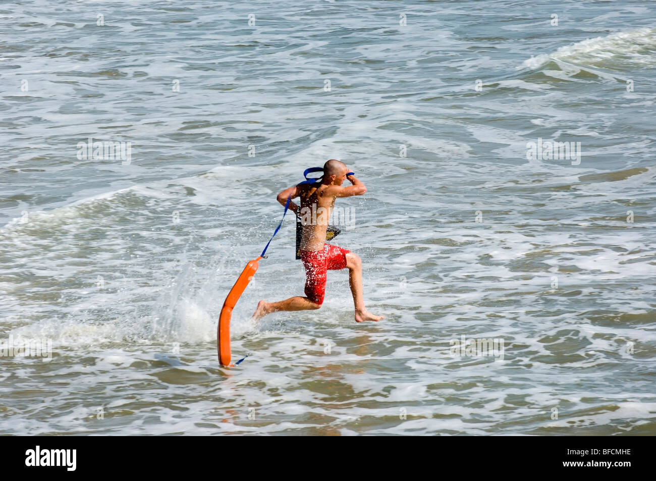 lifeguard running to rescue a drowning person Stock Photo Alamy