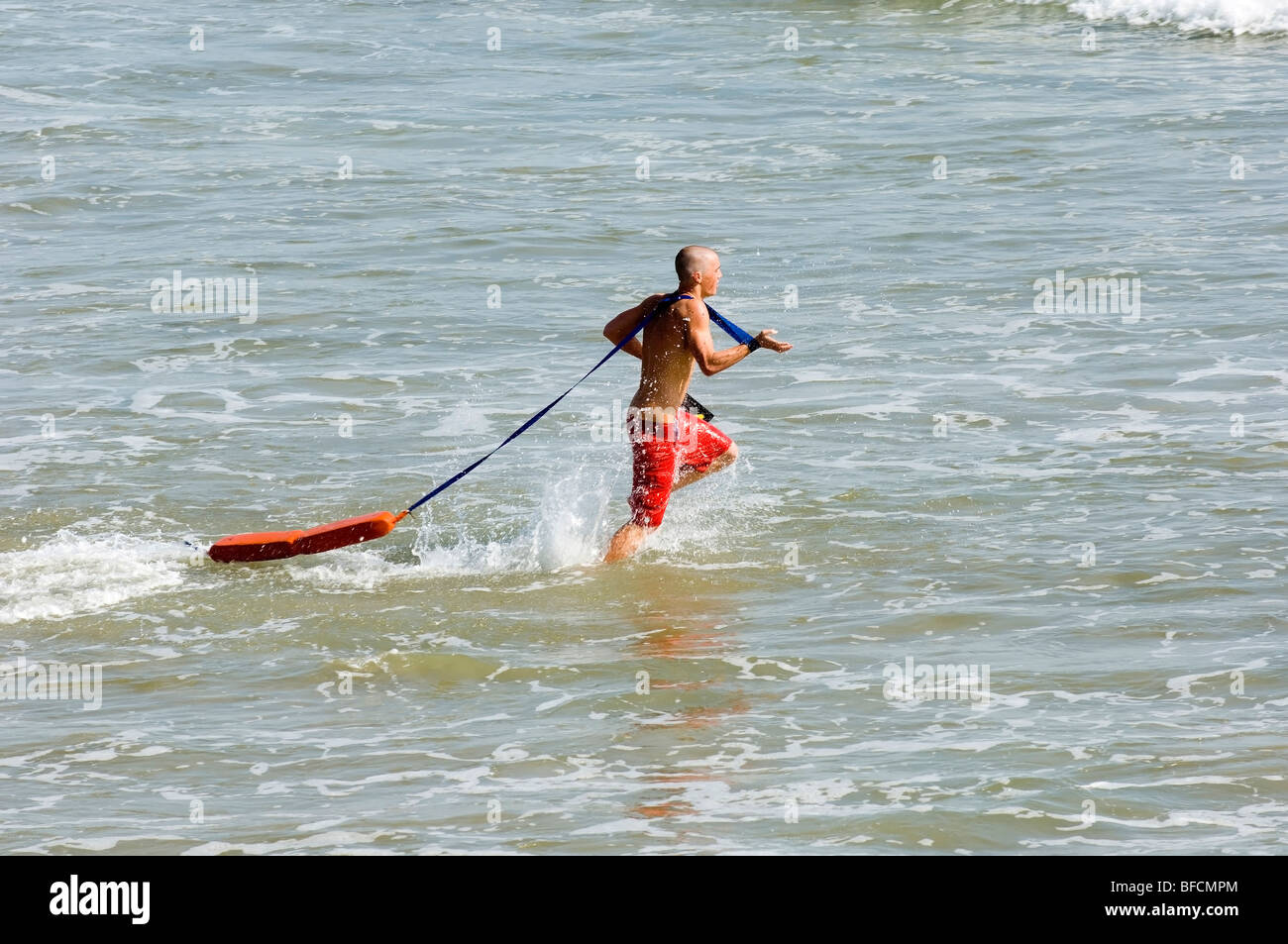 lifeguard running to rescue a drowning person Stock Photo Alamy