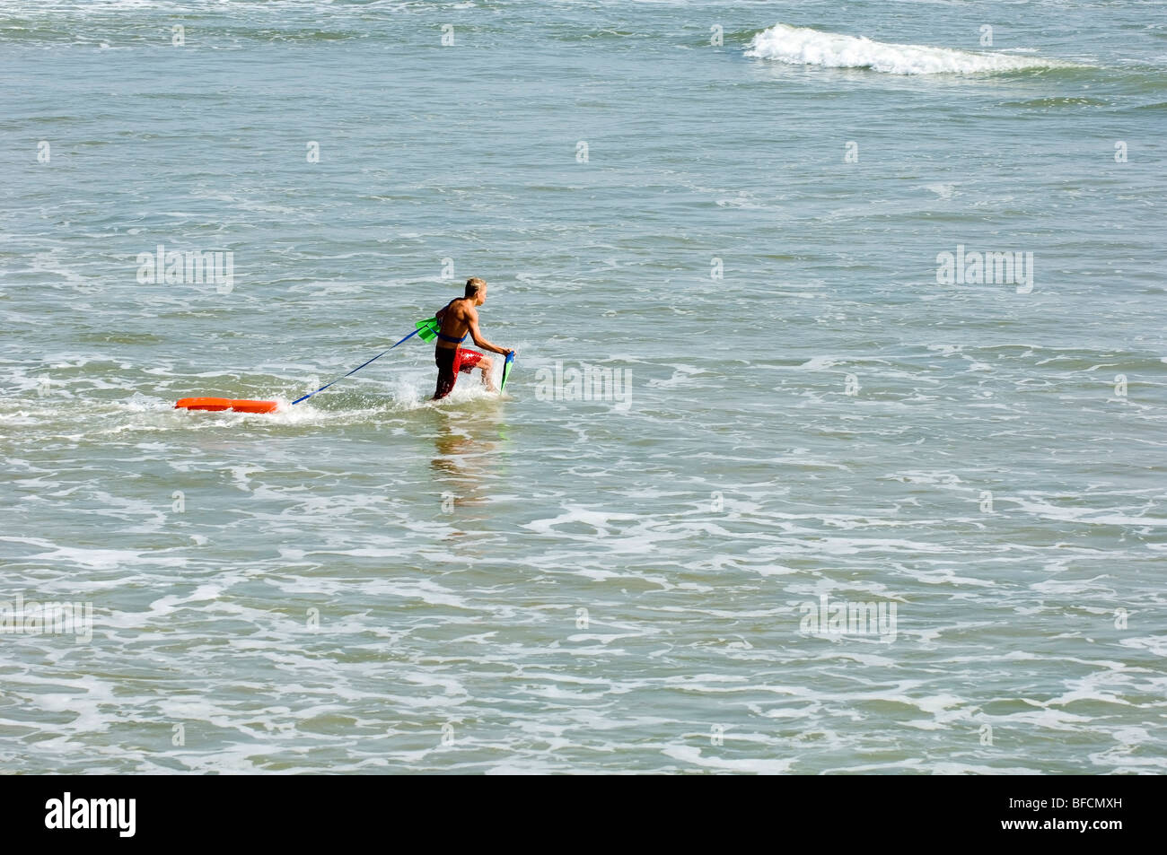 lifeguard running to rescue a drowning person Stock Photo Alamy