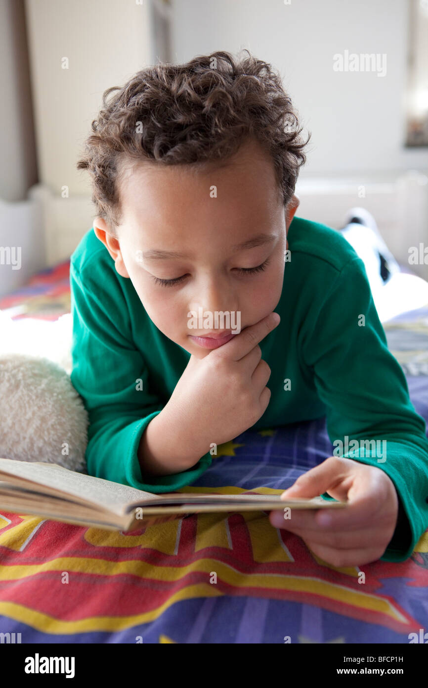 Seven year old boy reading a book Stock Photo Alamy