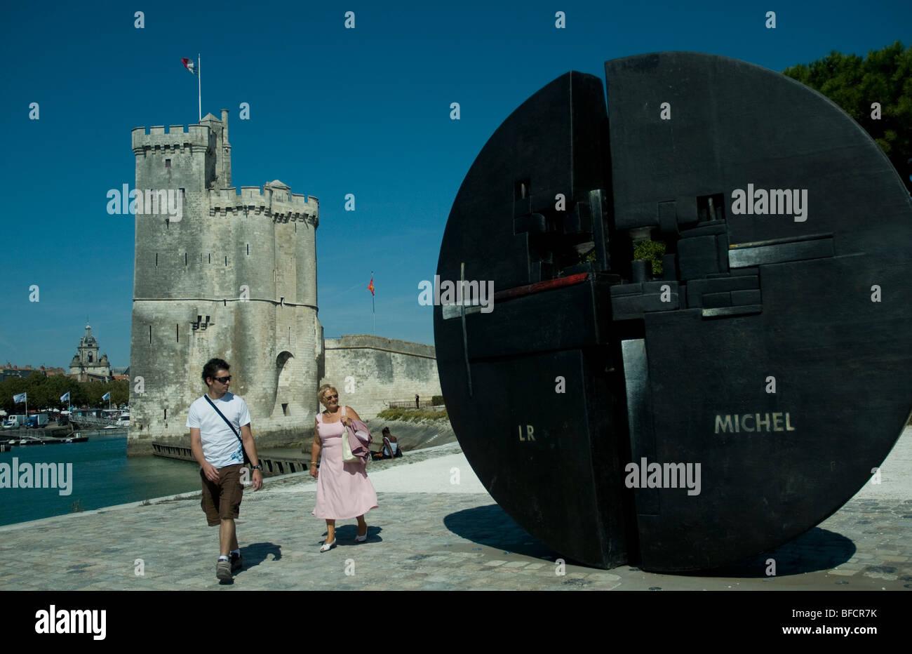 A great black disk stands artfully near the Saint-Nicolas tower at the entrance to La Rochelle's Old Port Stock Photo