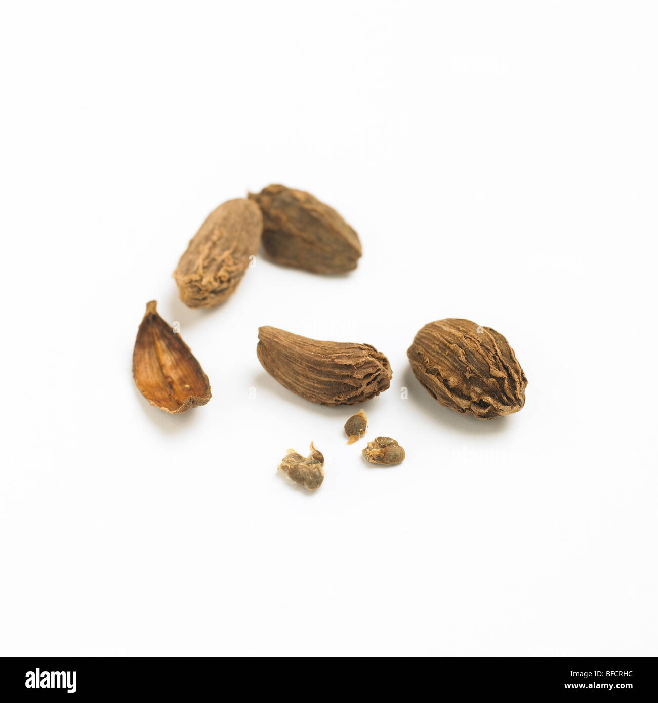Black cardamom pods and seeds on a white background Stock Photo Alamy
