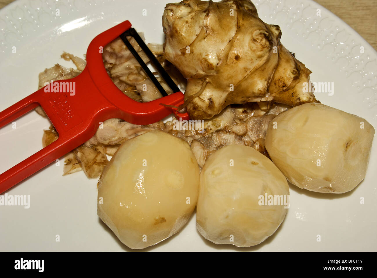 Peeled Jerusalem artichoke tubers are edible raw or steamed Stock Photo