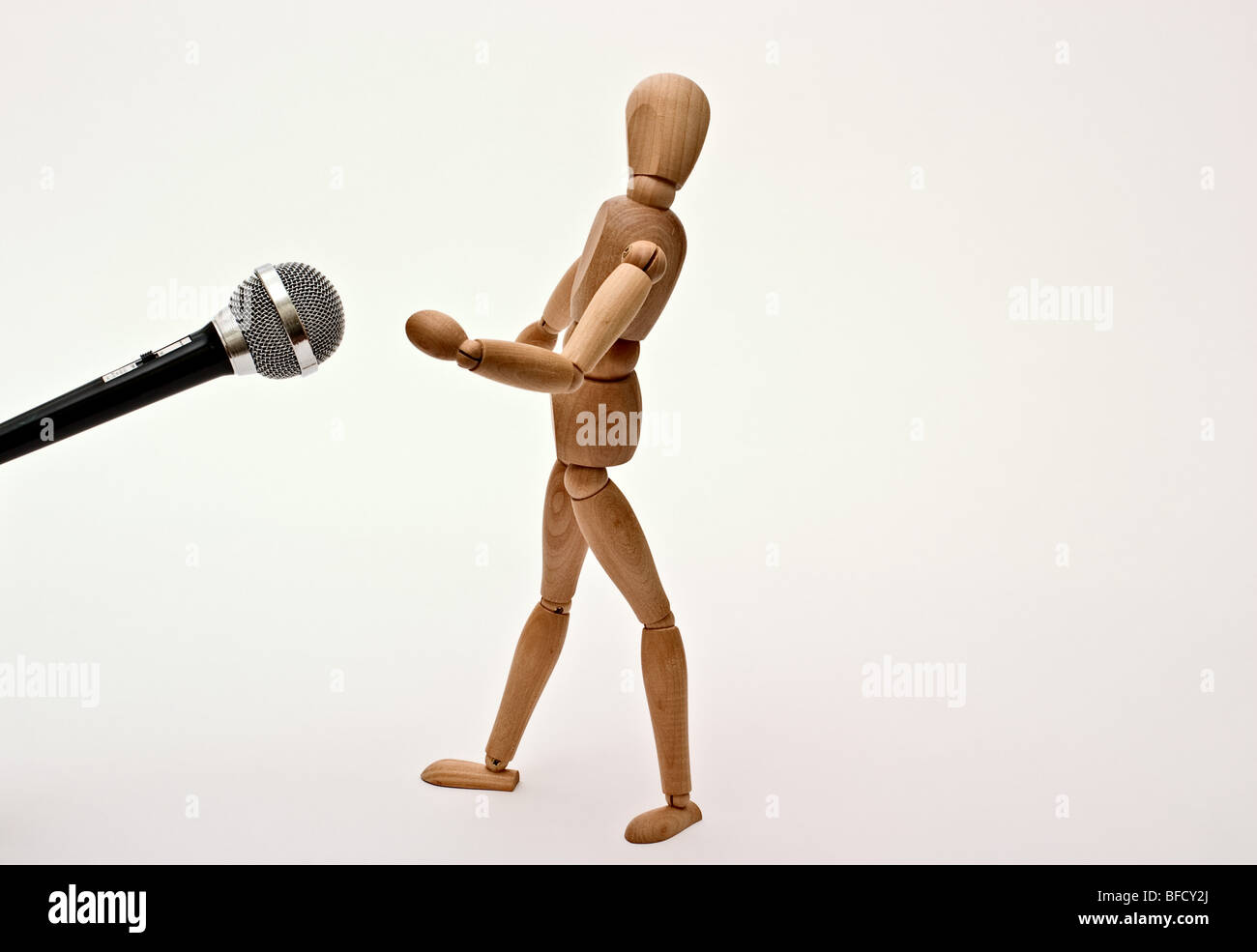 Artists Mannequin standing next to an old style microphone Stock Photo
