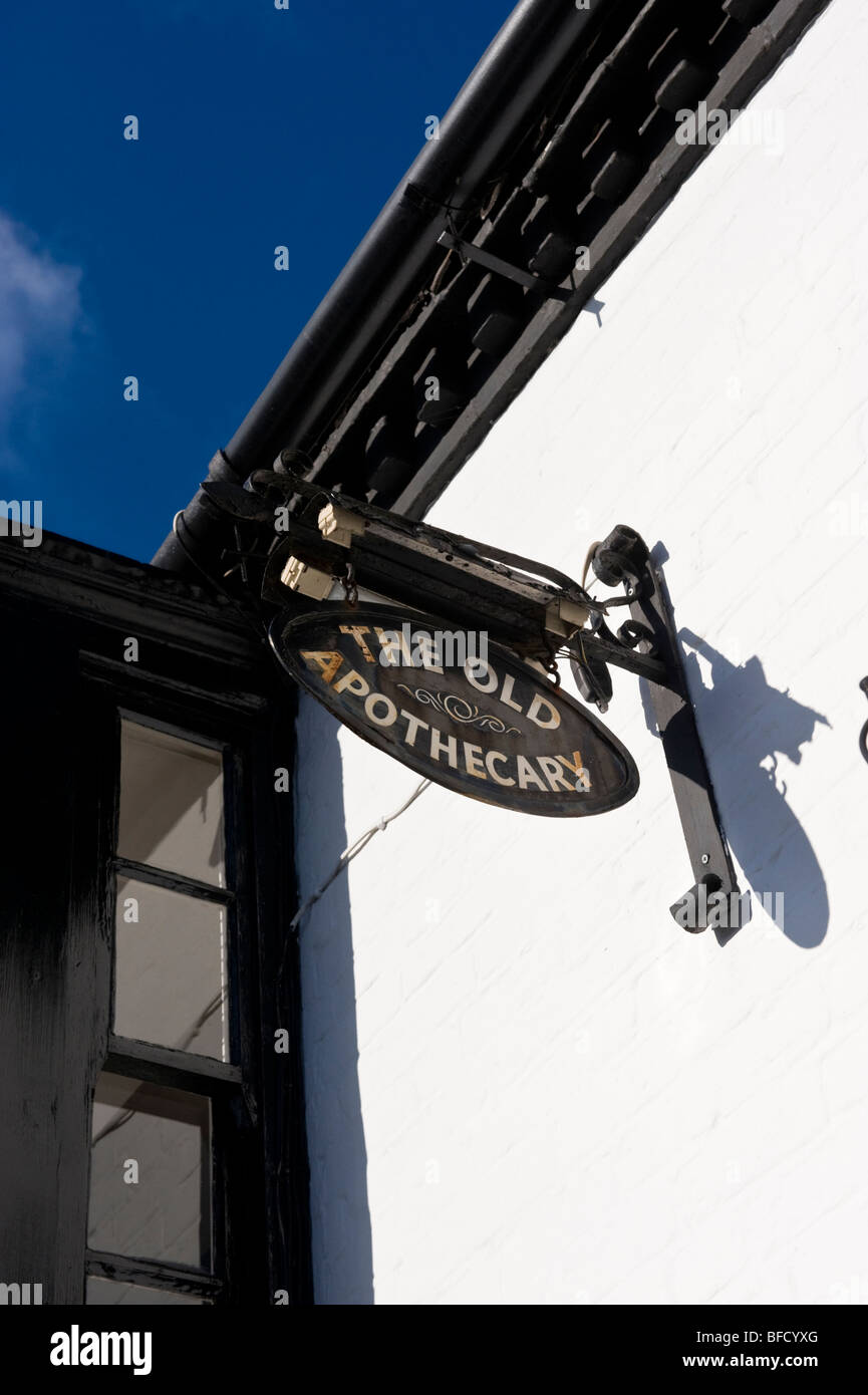 A traditional hanging shop sign on a building at High Street, Cookham