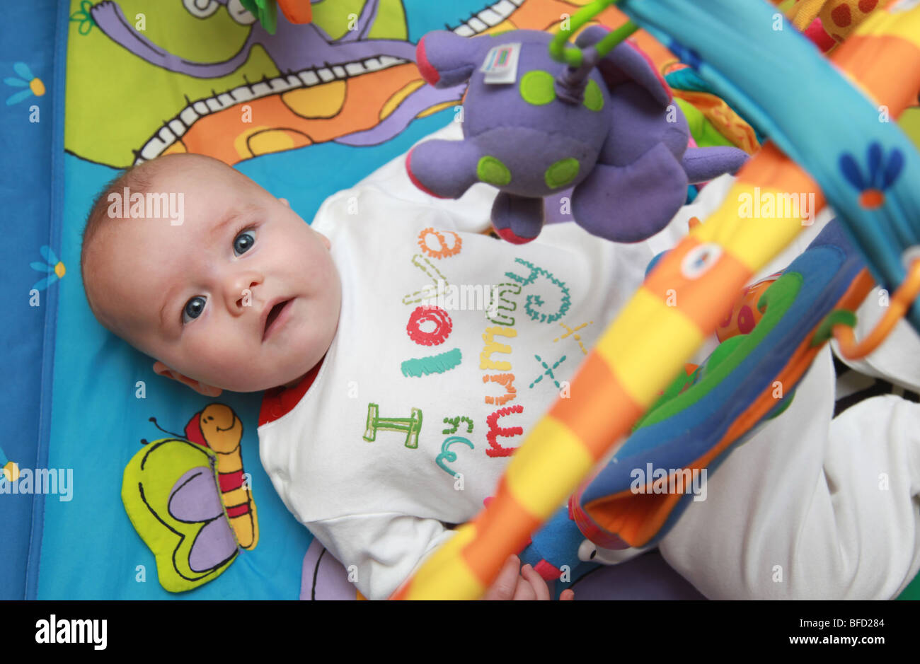 2 month old baby playing with his jungle gym. Stock Photo