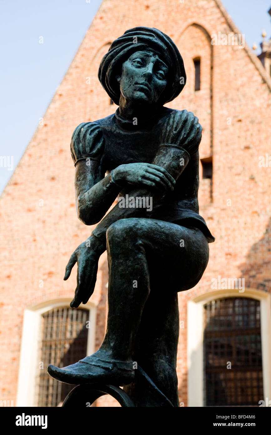 Bronze figure of a student, above the water fountain in St Mary's Square, Krakow. Poland. Stock Photo