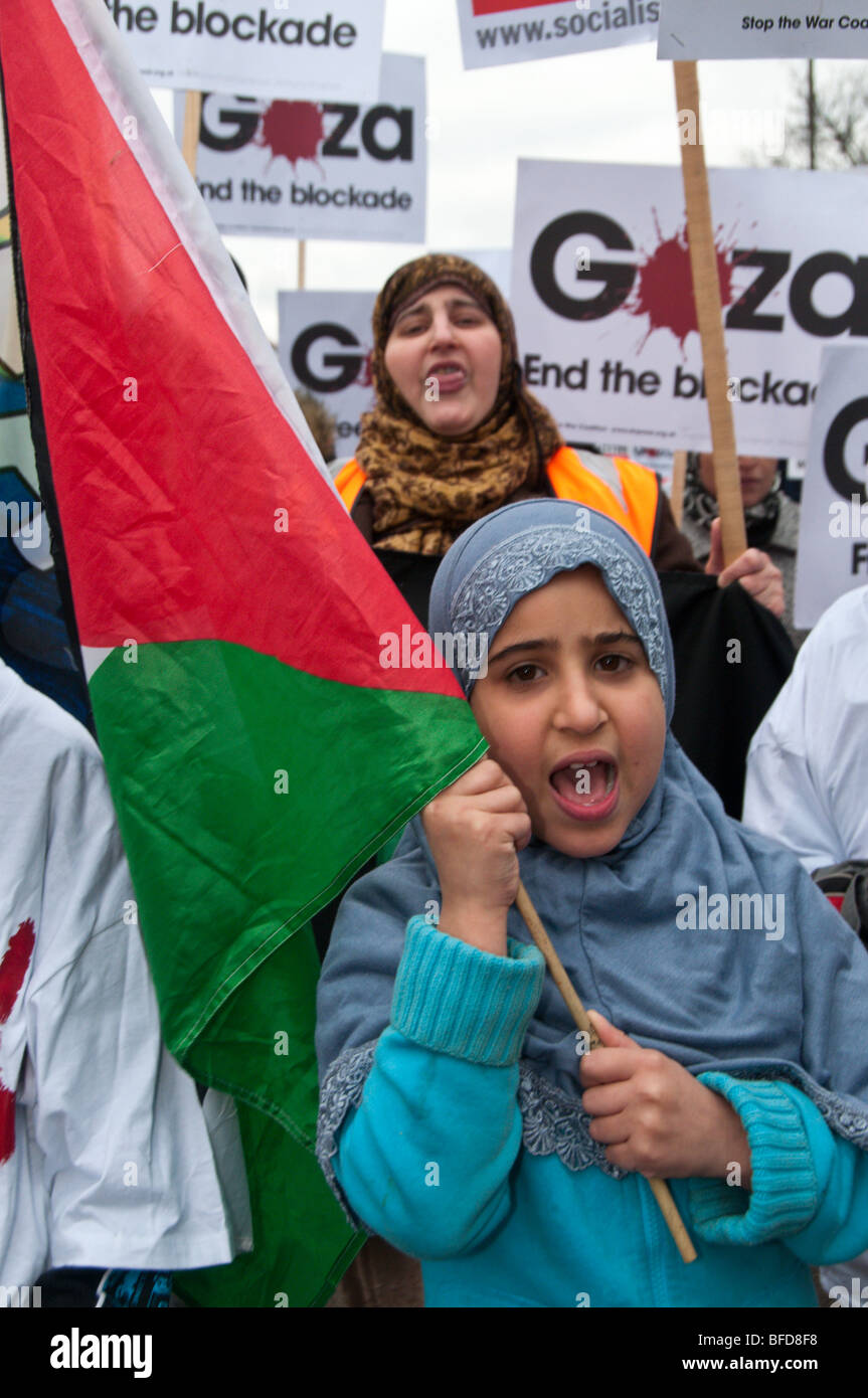 South London March for Palestine. Young Muslim girl with Palestinian flag in march Stock Photo