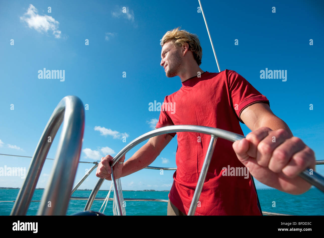 A man pilots a boat off of Florida Stock Photo Alamy