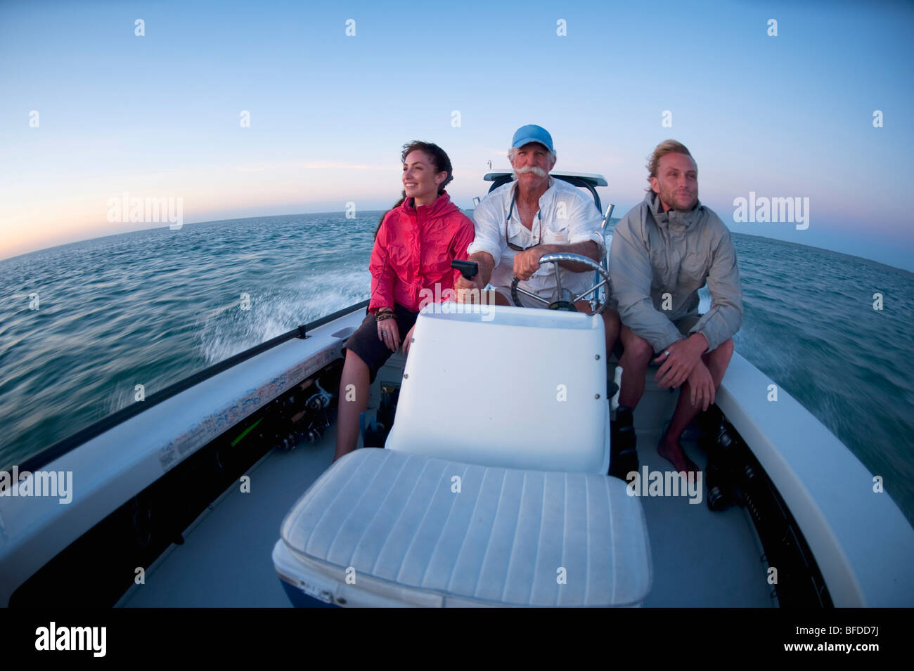 Three people in a boat hi-res stock photography and images - Alamy