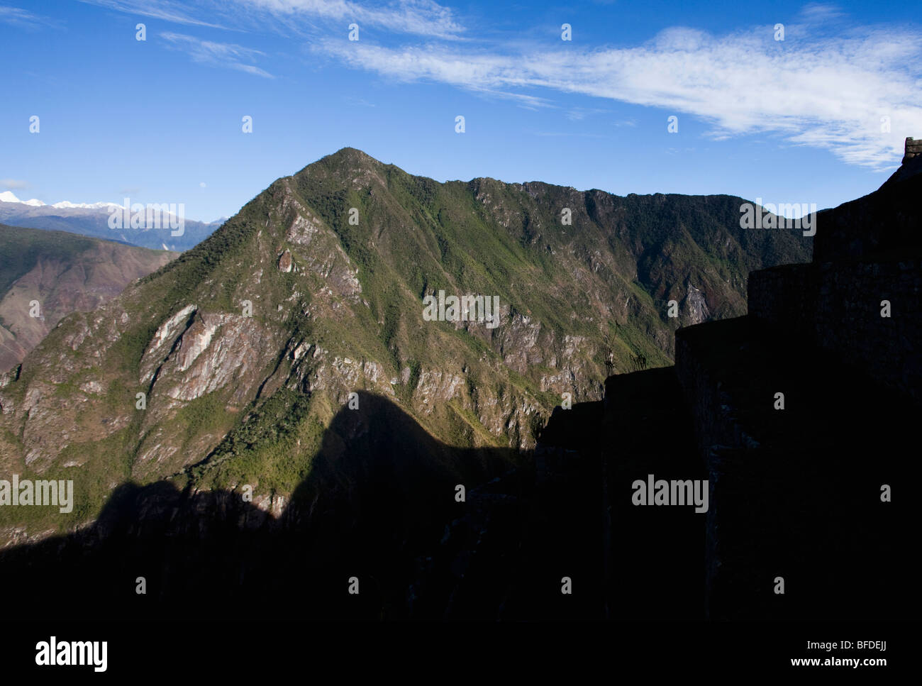 The silhouette of terraces and a mountain with a dramatic mountain range in the background. Stock Photo