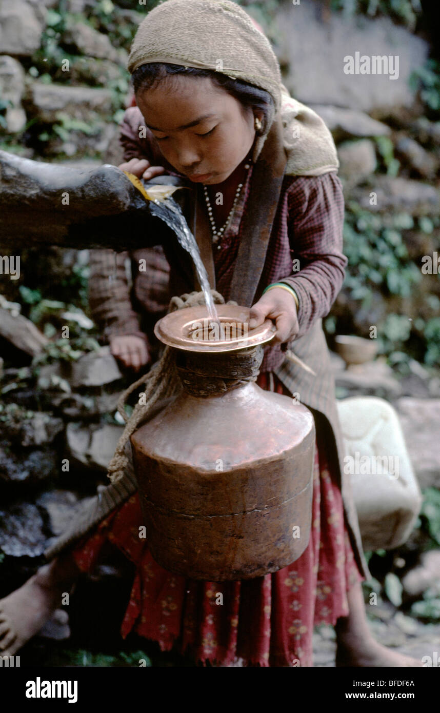 Village Tamang girl pottering water to their home. Stock Photo