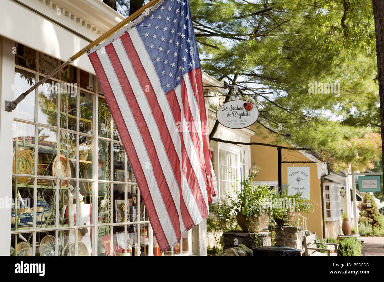 American flag in picturesque smalltown souvenir shops setting. Stock Photo