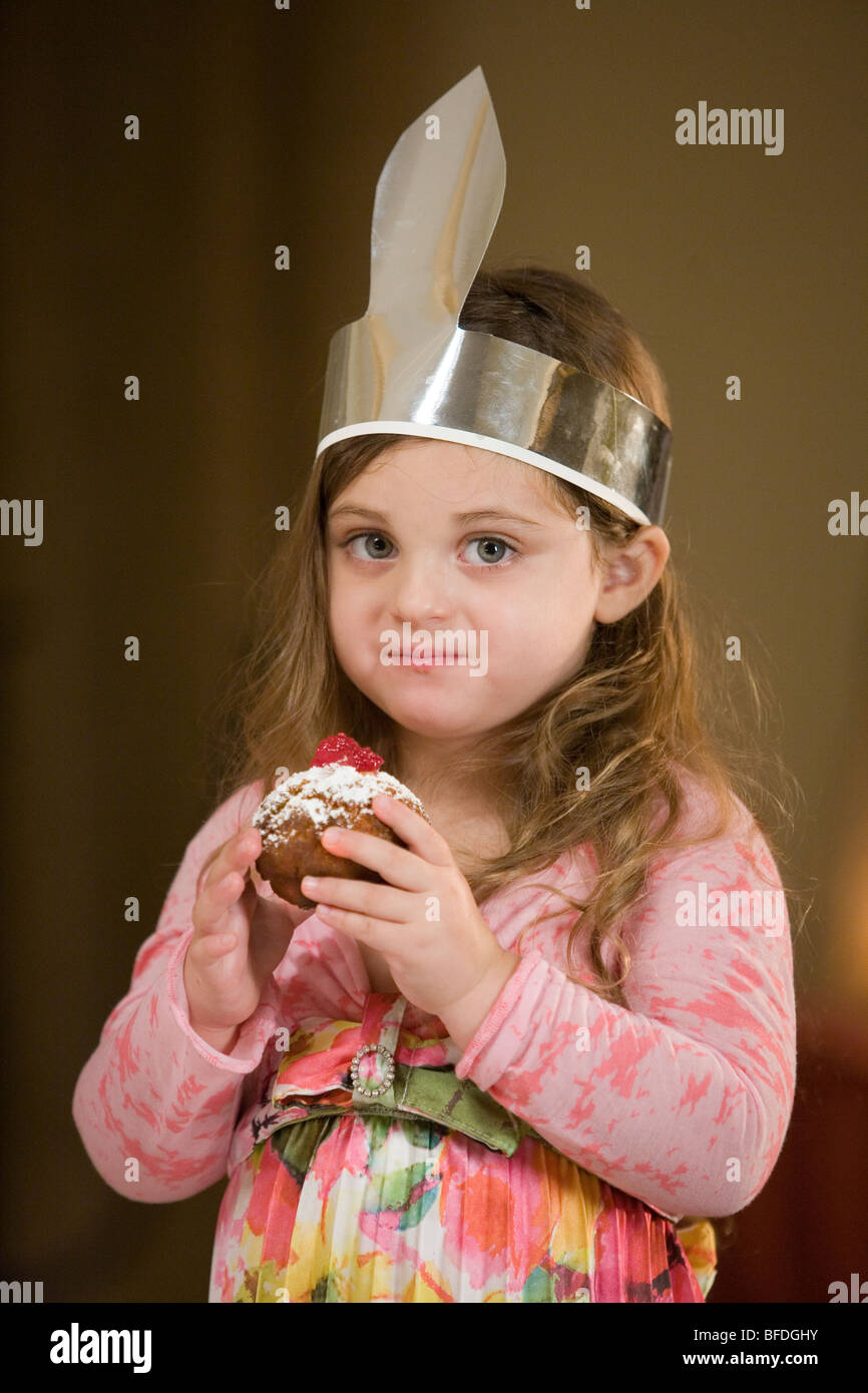 Girl holding a jelly doughnut Stock Photo - Alamy