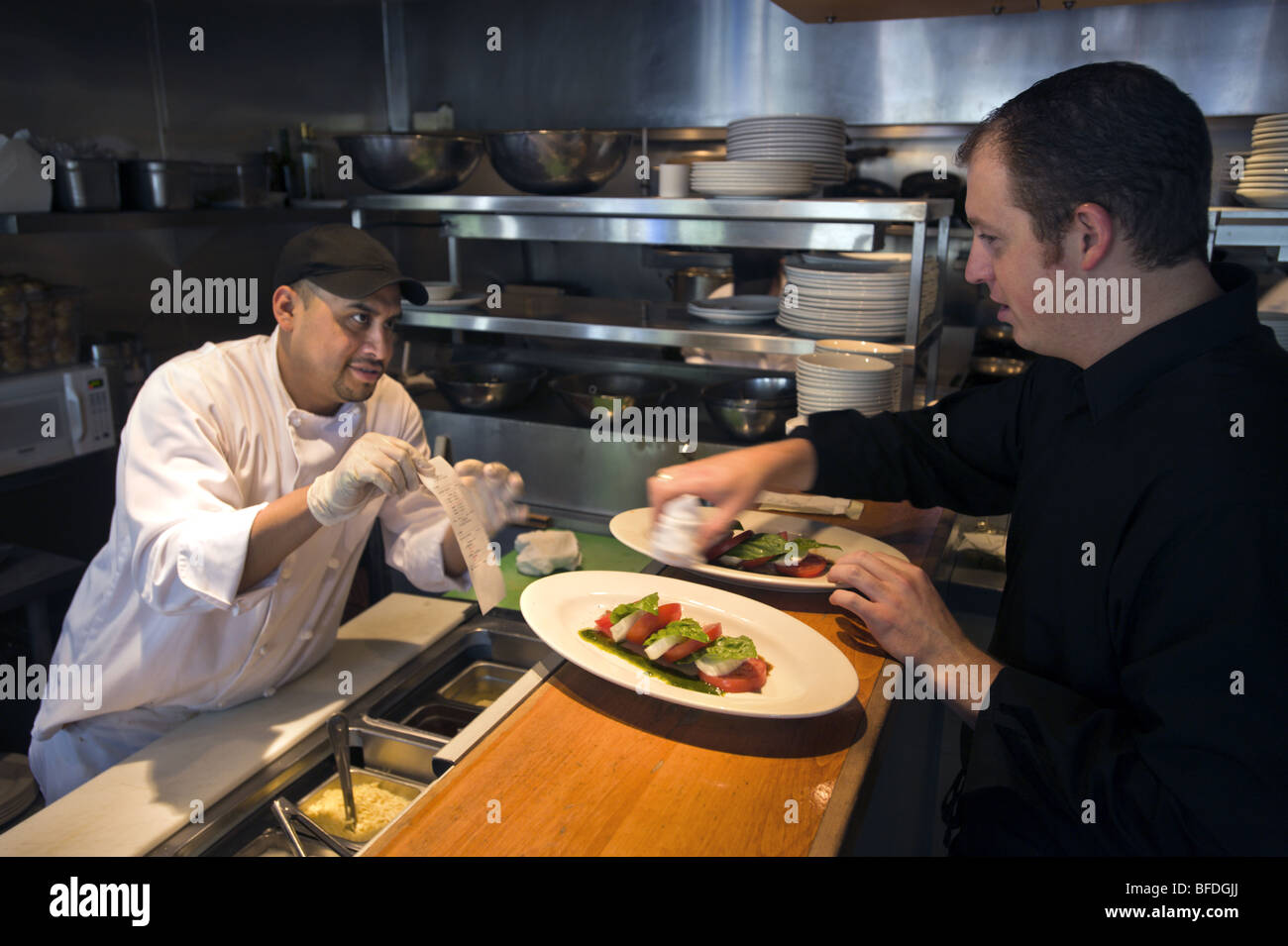 A hispanic worker works as a cook at an upscale Italian restaurant, Cucina Colore, in the Cherry Creek North area of Denver, Col Stock Photo