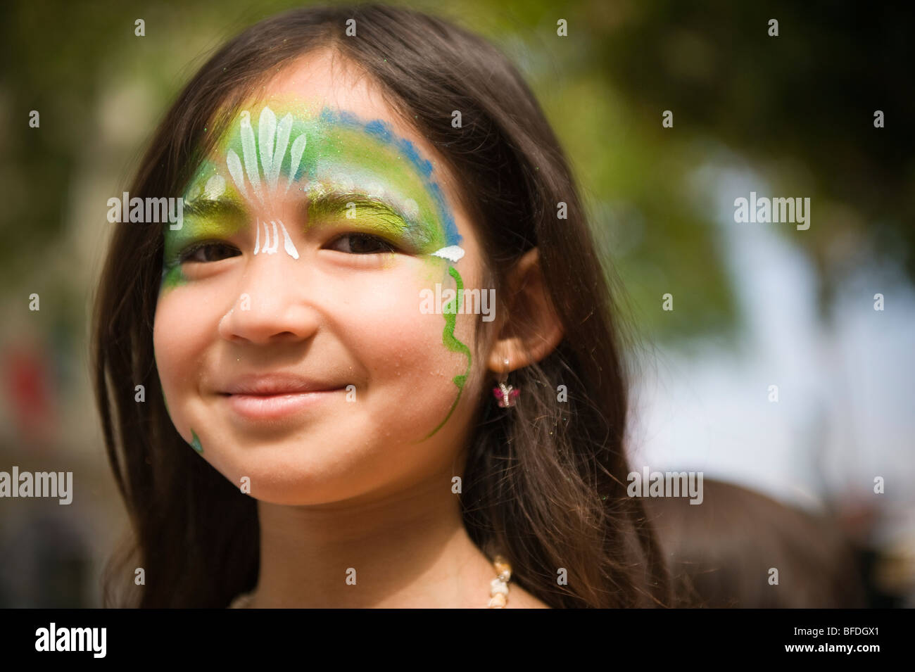 A young girl with painted face at a parade in Santa Barbara. The parade