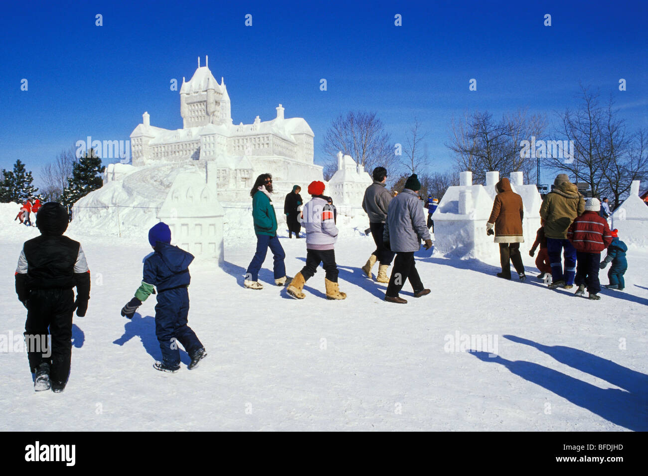 Group of people walking by snow sculpture at Winterlude Festival