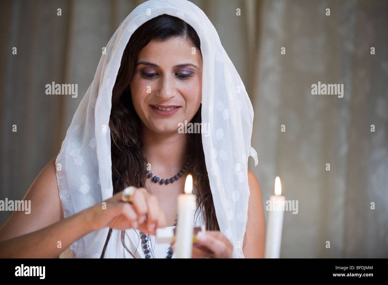 Woman lighting Shabbat candles. Stock Photo