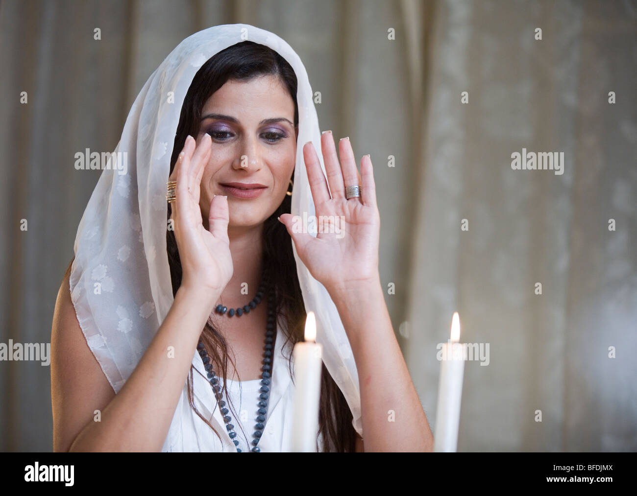 Woman lighting Shabbat candles Stock Photo Alamy