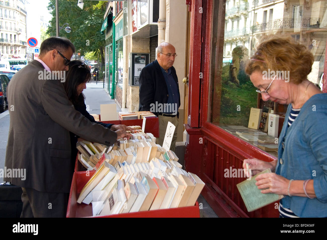 Bookseller cleaning a second-hand book in Paris, France. Stock Photo