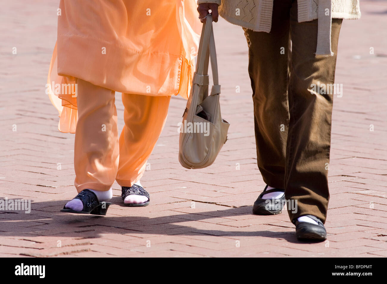 Asian Indian and friend walking. Stock Photo