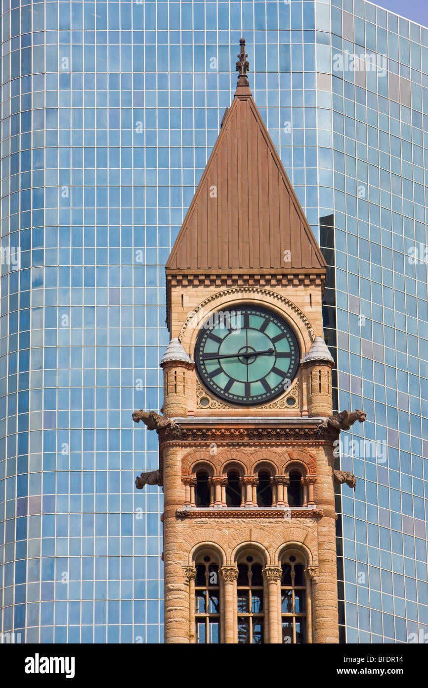 Clock tower of the Old City Hall surrounded by modern buildings in