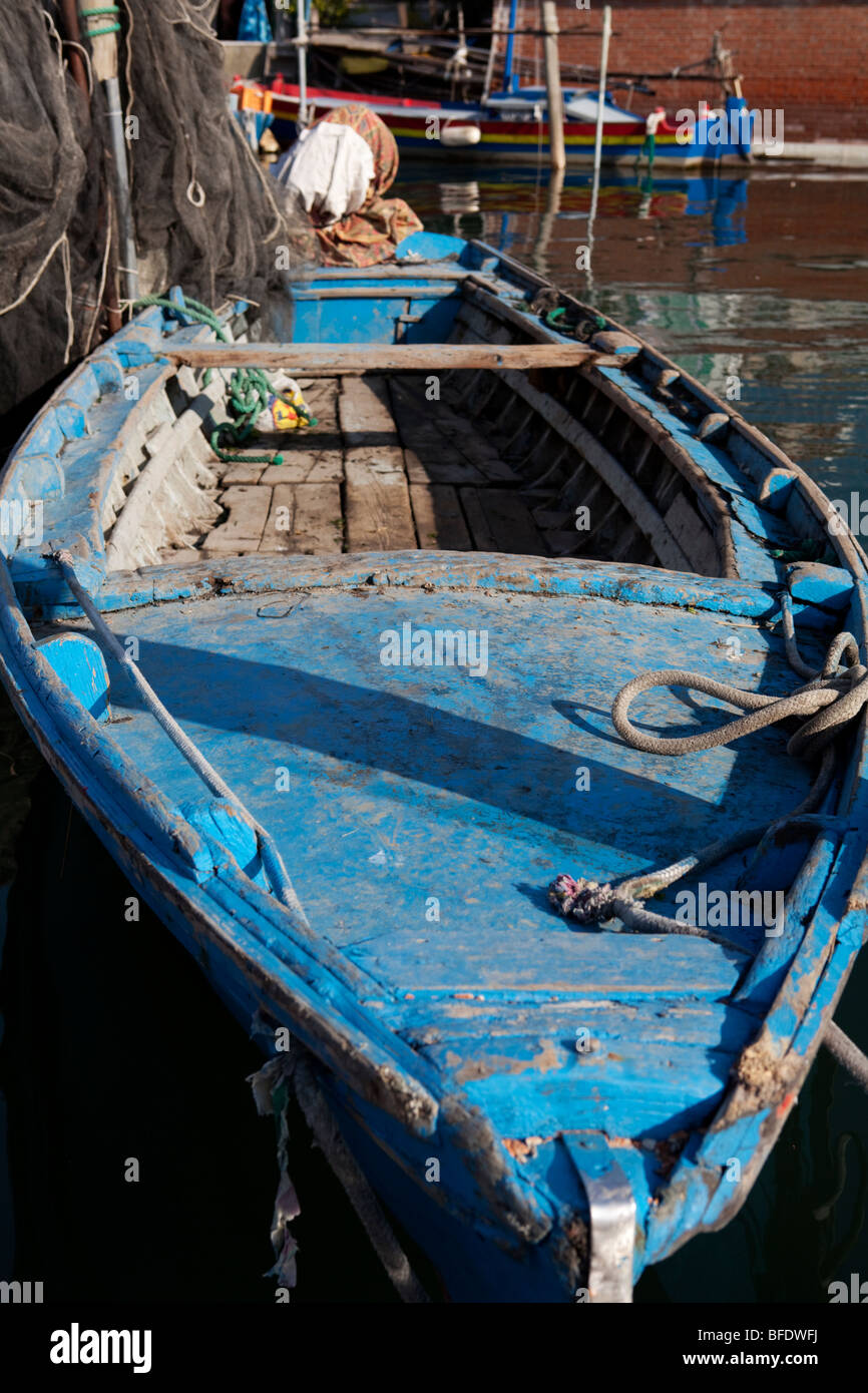 Old blue wooden fishing boat anchored in the canal in Chioggia, Venice ...