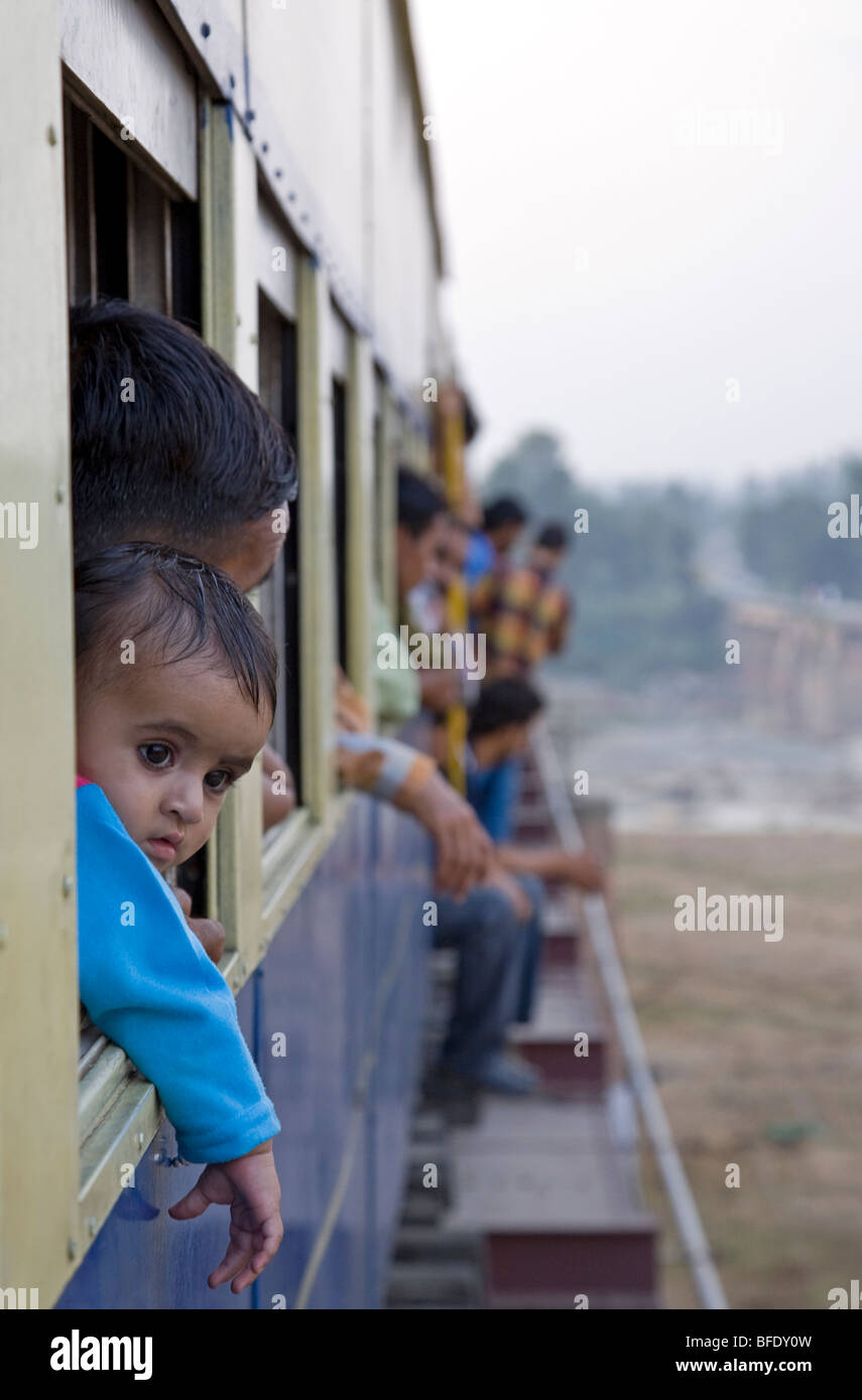 Passengers looking through the windows. Train Kangra-Pathankot. Himachal Pradesh. India Stock Photo