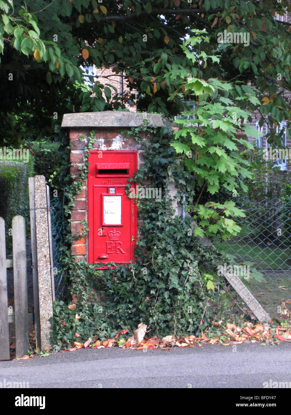 Old fashioned village wall mounted red post or pillar box Stock Photo