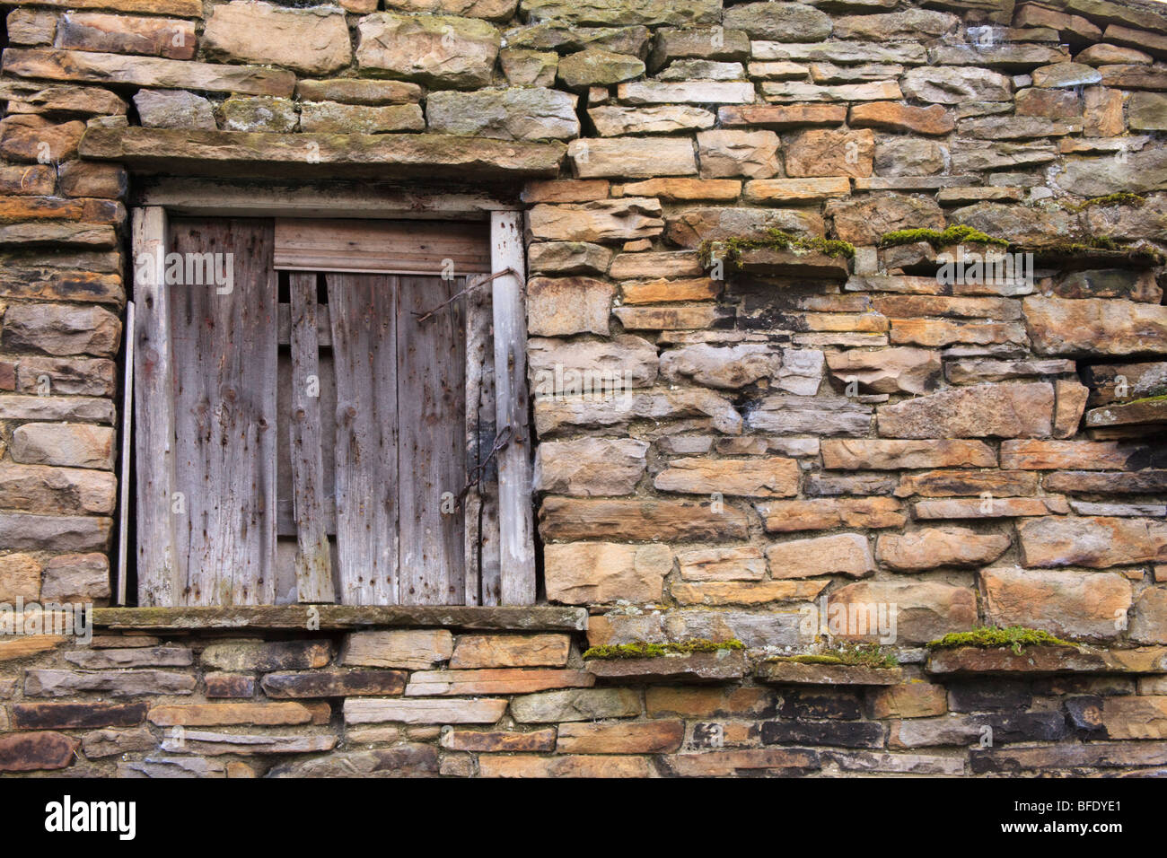 Window in the side of a stone wall of a typical barn in Thwaite Swaledale Yorkshire dales Stock Photo