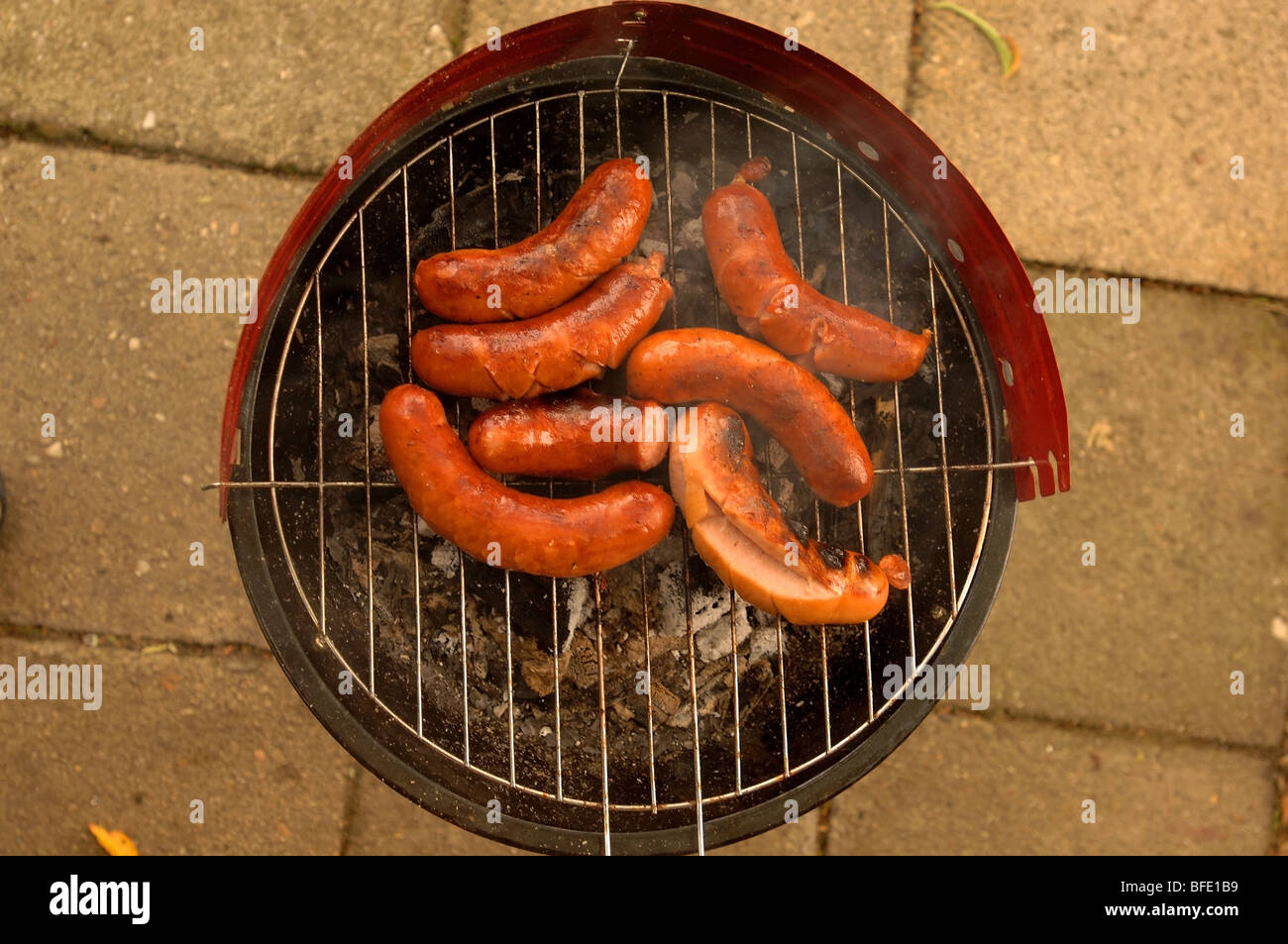 Polish sausages on a small grill. Stock Photo