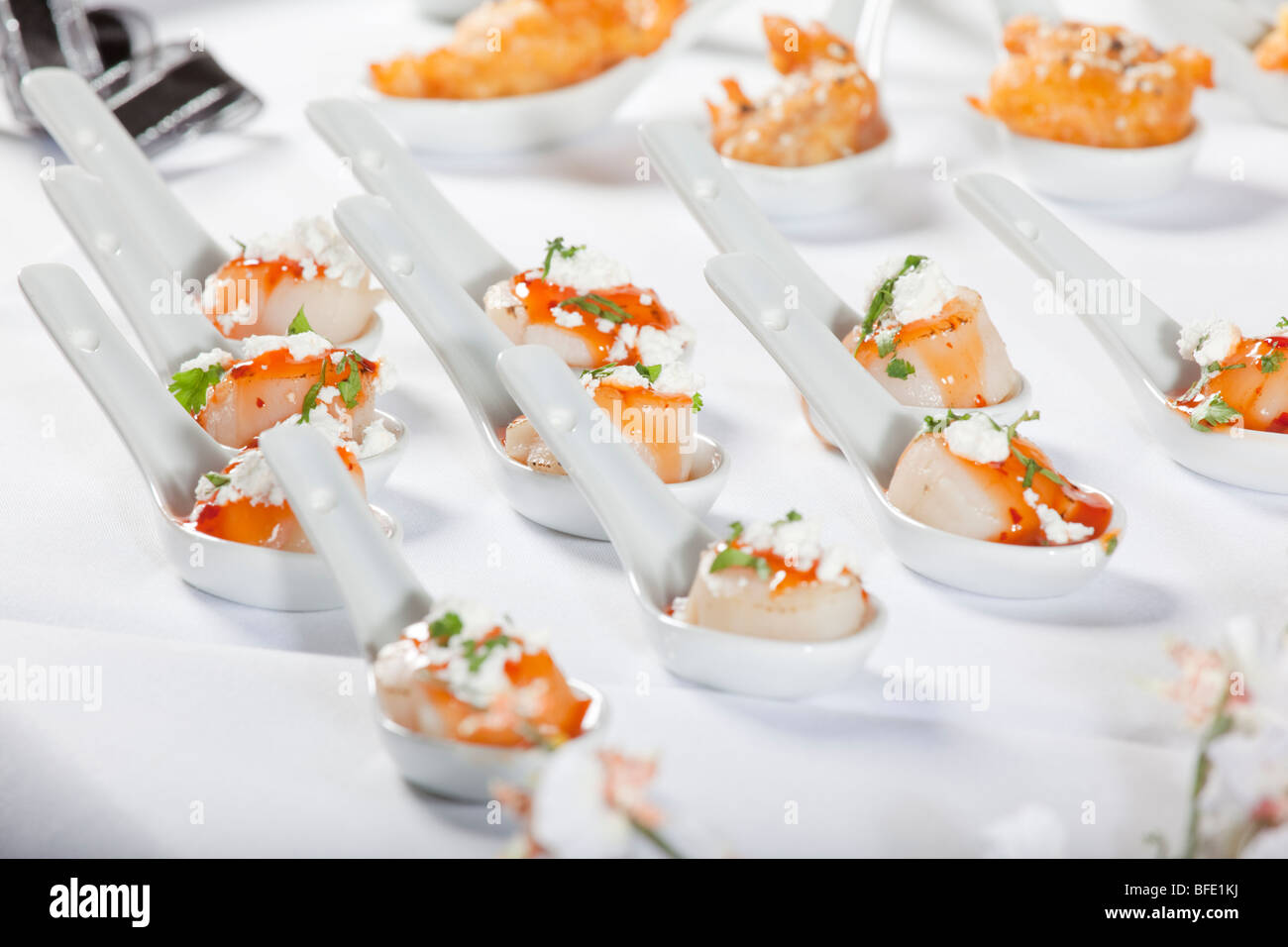 Scallops served on white spoon Stock Photo