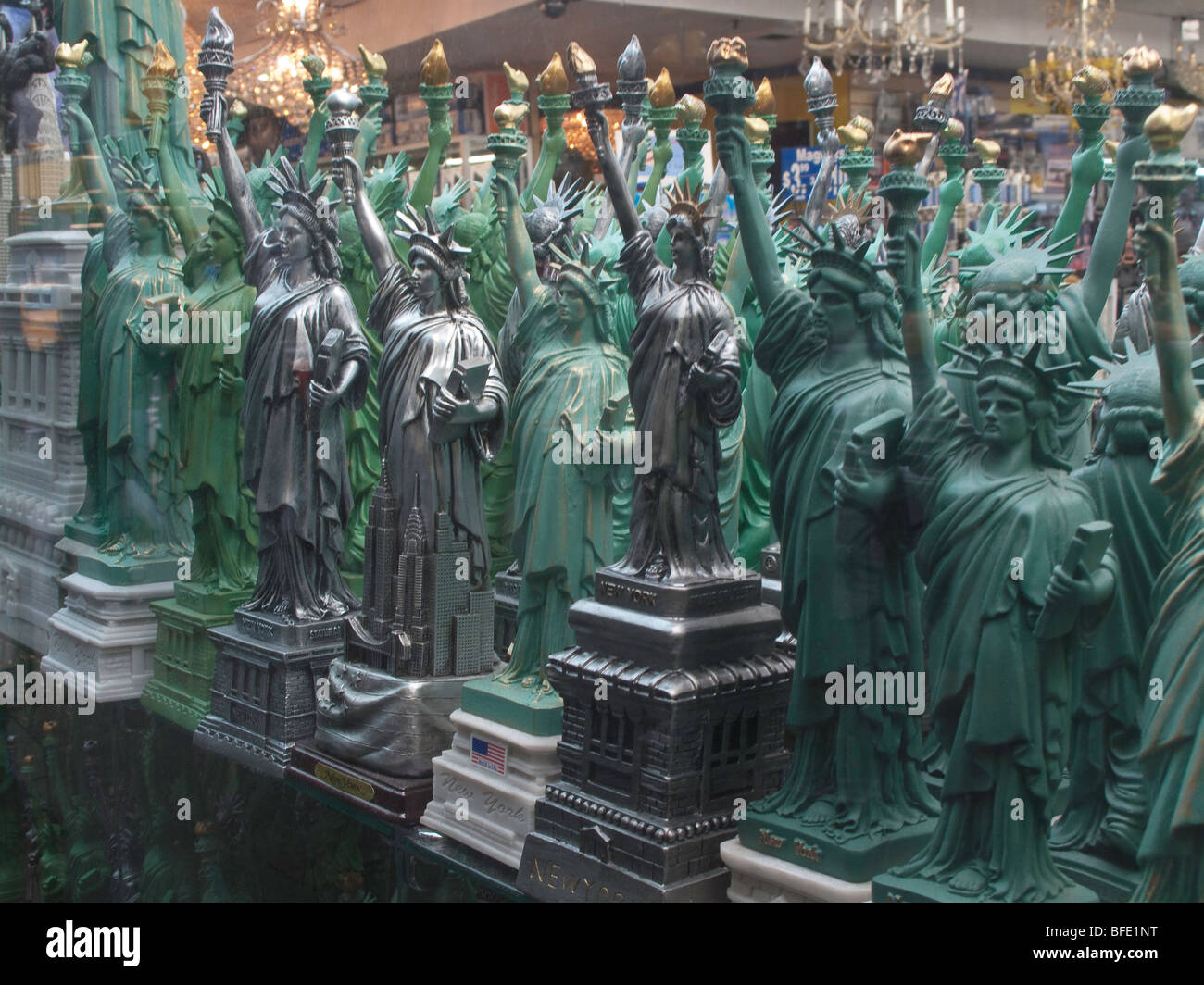 Miniature statues of liberty on display in a Times Square store window