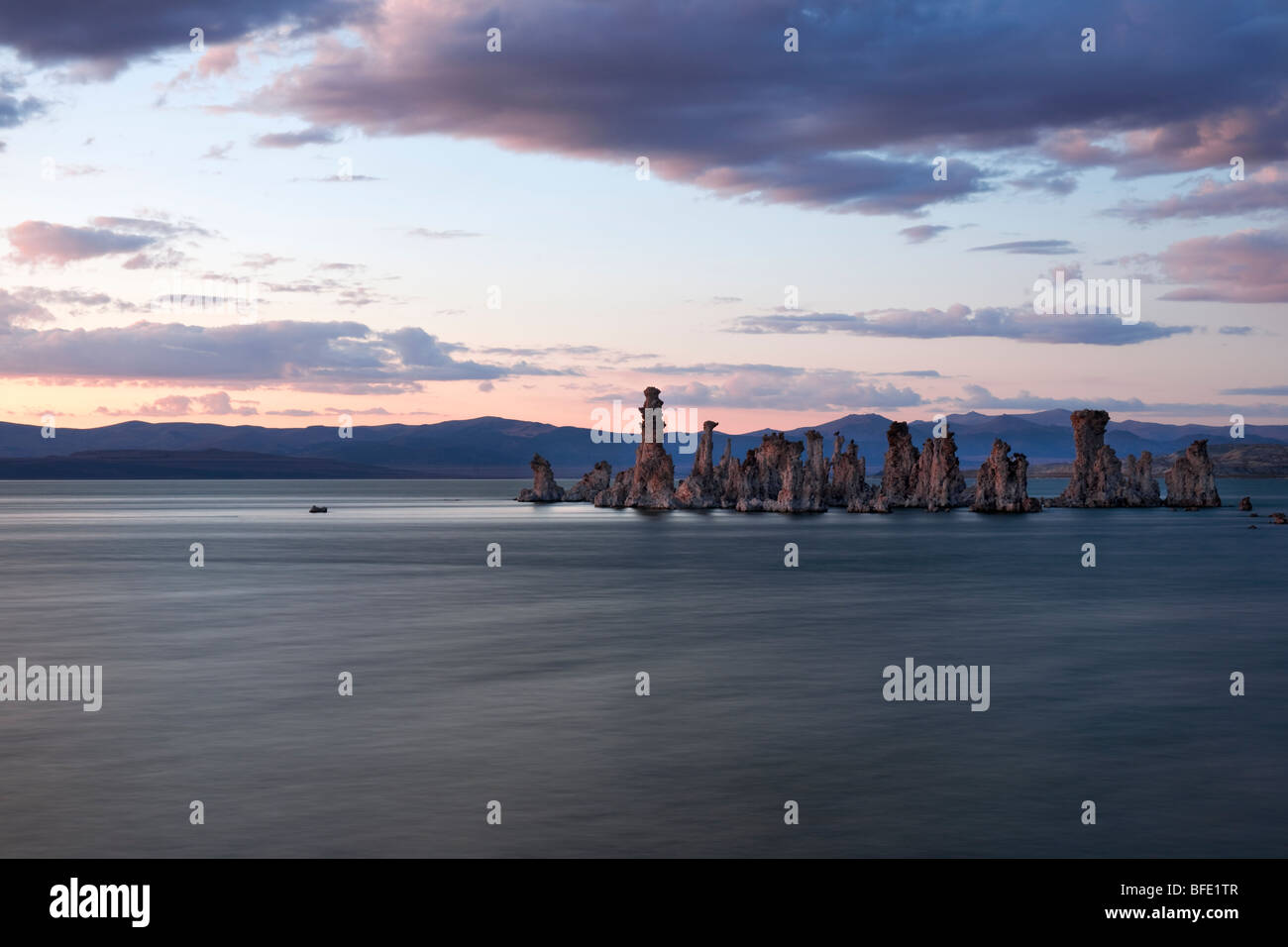 Twilight over California's Mono Lake and a pair of owls sit atop the offshore tufa towers. Stock Photo