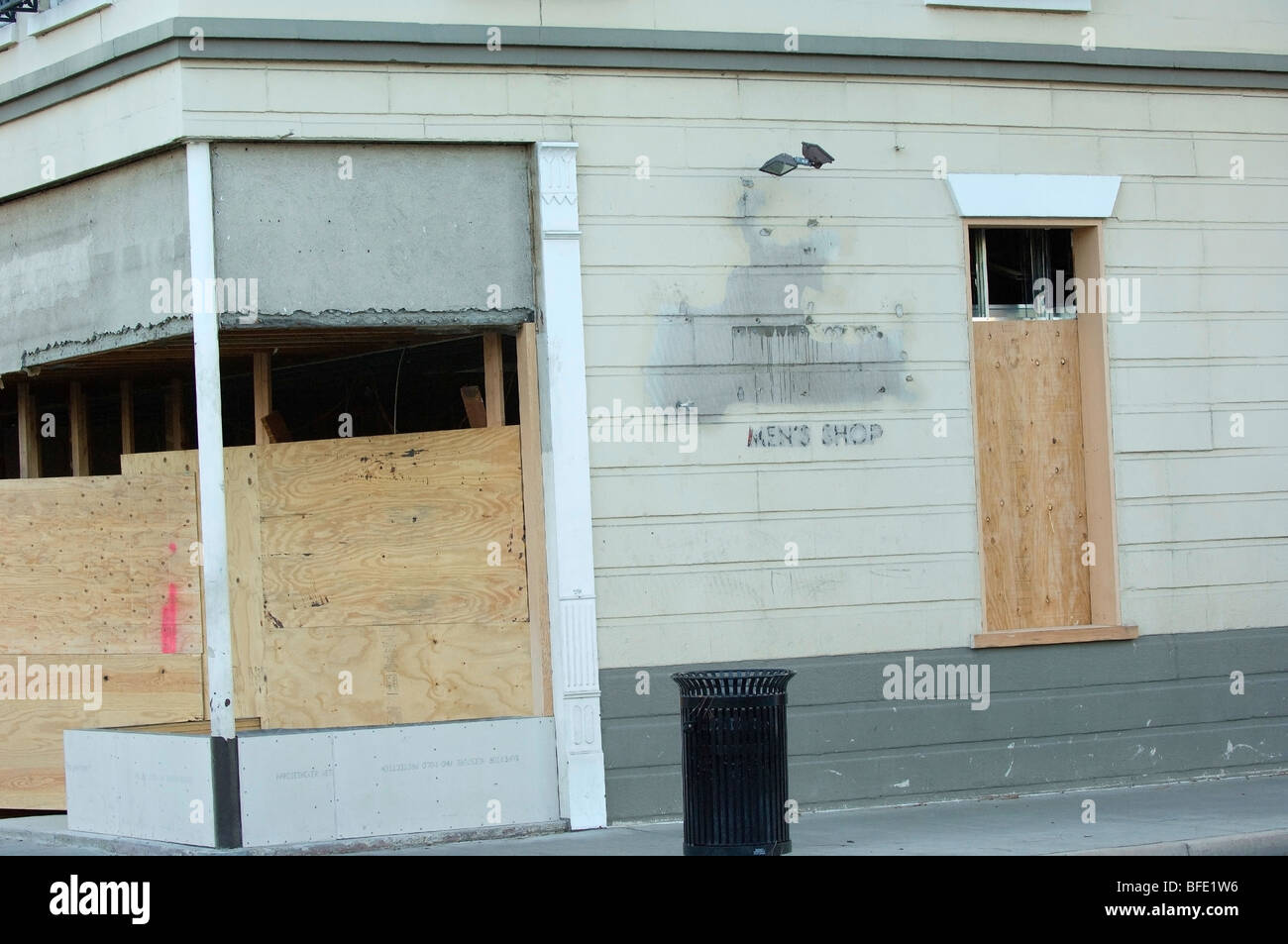 A business storefront with boarded up windows. (Concepts: new business, going out of business, fire/natural damage, repair). Stock Photo