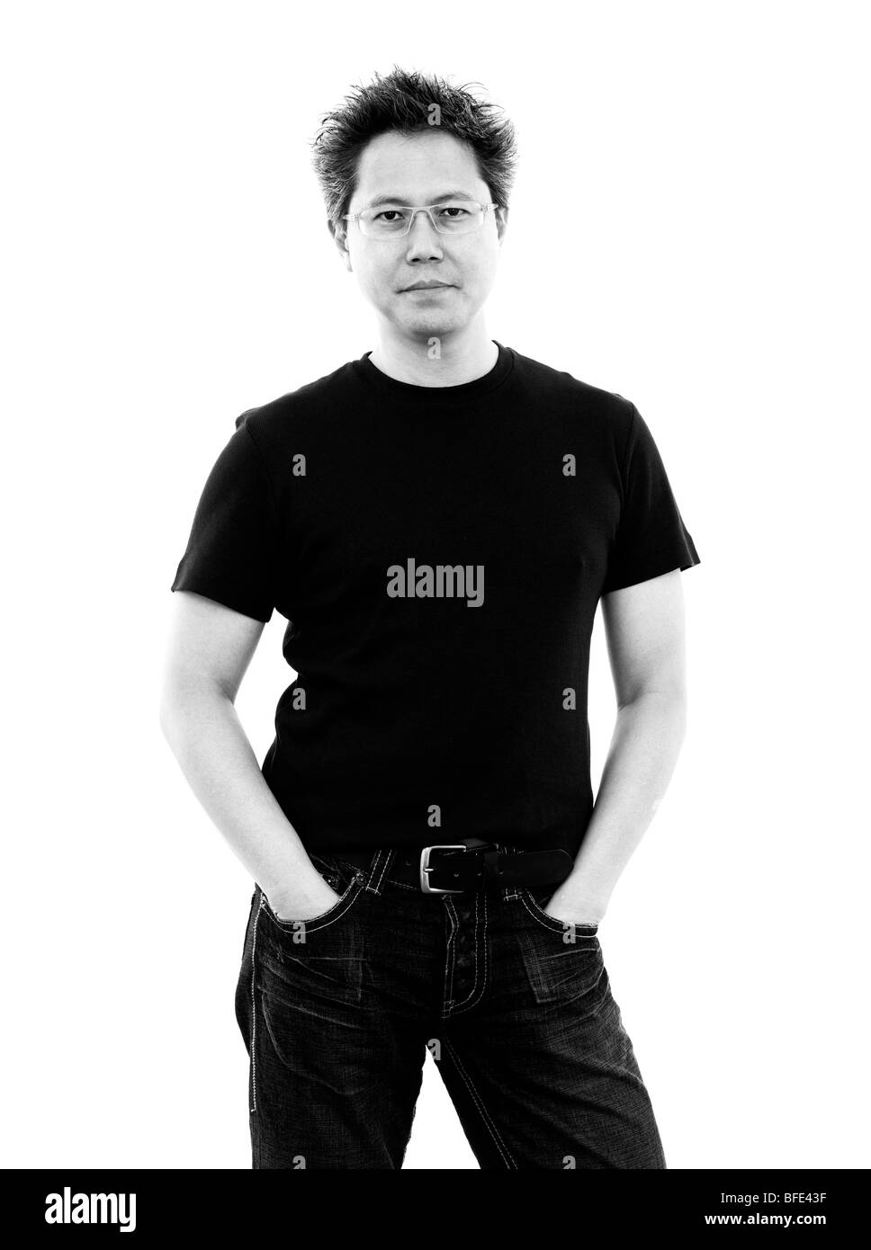 44 year old Asian male wearing jeans and a t-shirt standing against a white background Stock Photo