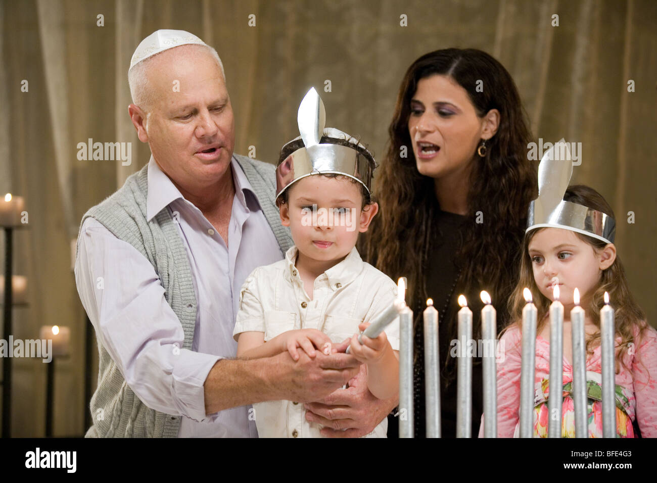 Family lighting Hanukkah candles Stock Photo - Alamy