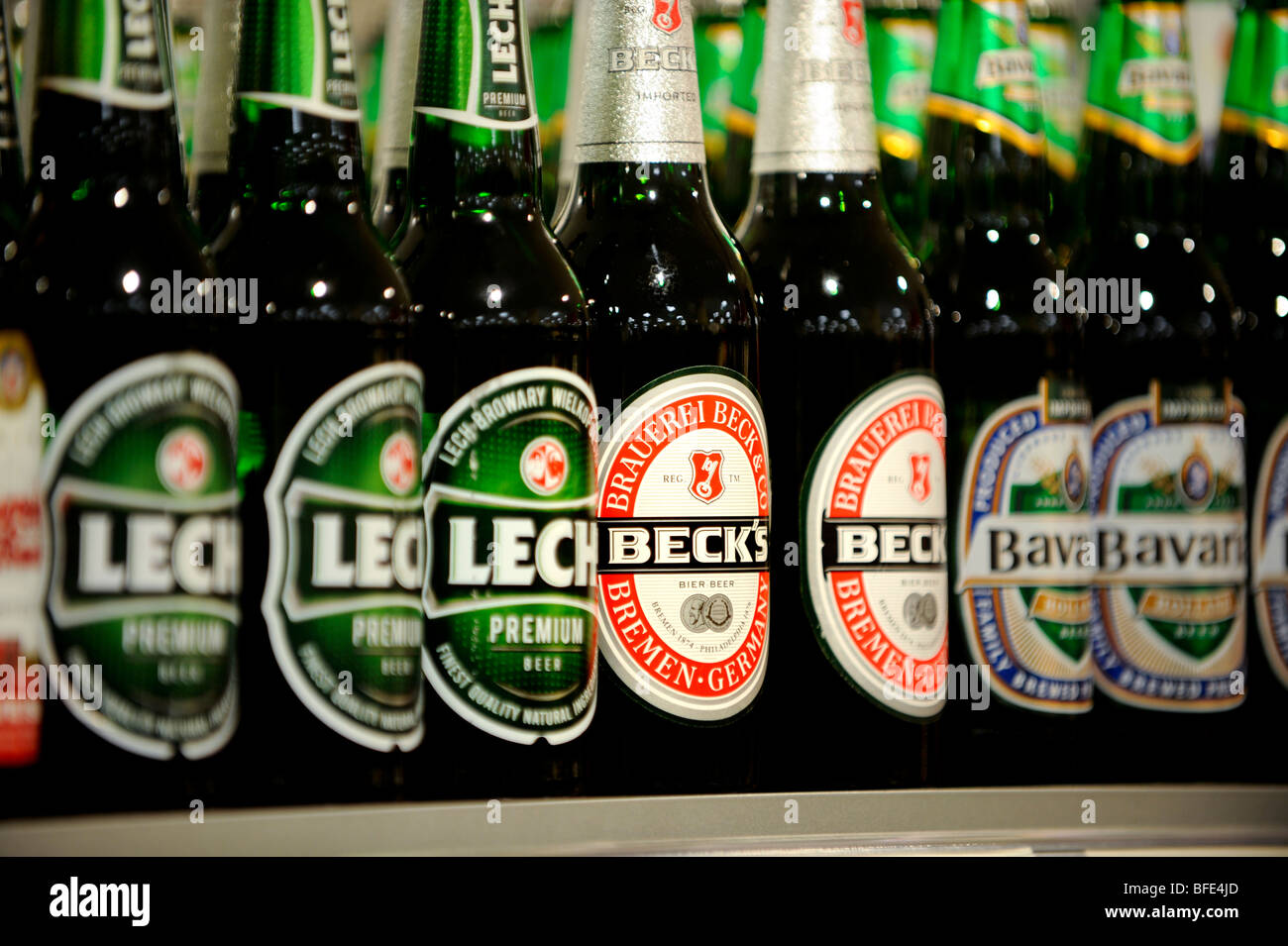 Shelves in a supermarket stacked with Becks and Lech bottled beers. Stock Photo
