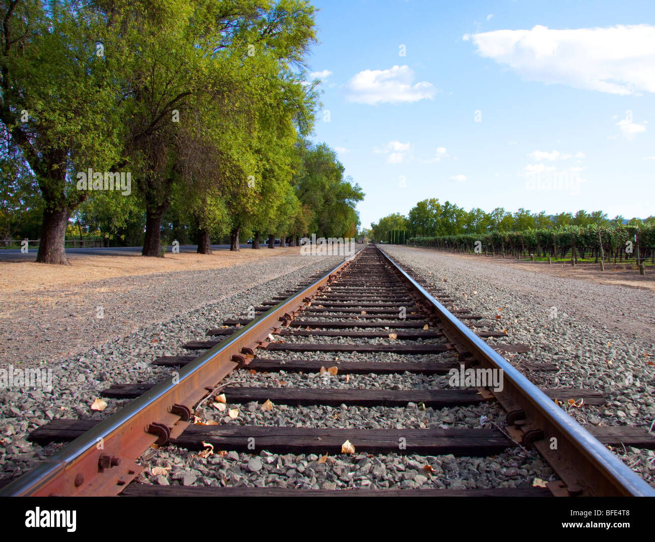 Straight railroad tracks appearing to converge in the distance hires stock photography and