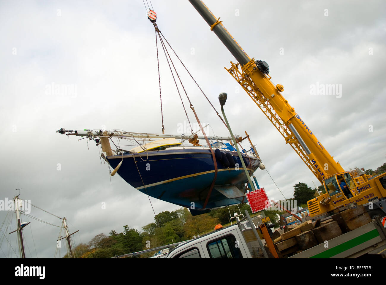 yacht hoisted by crane Stock Photo - Alamy