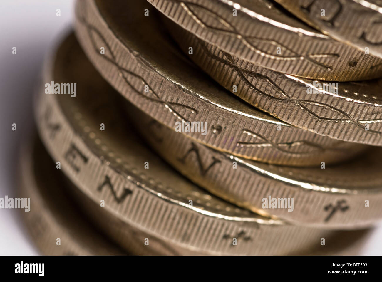 Money one pound coins stacked ion a white background Stock Photo